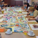 Carers working on their collaborative visual art piece